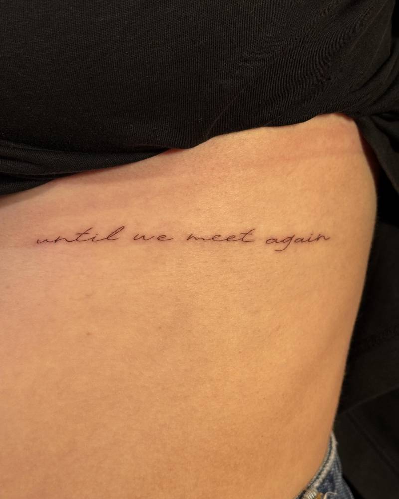 "Until we meet again" lettering tattoo handwritten on the rib.