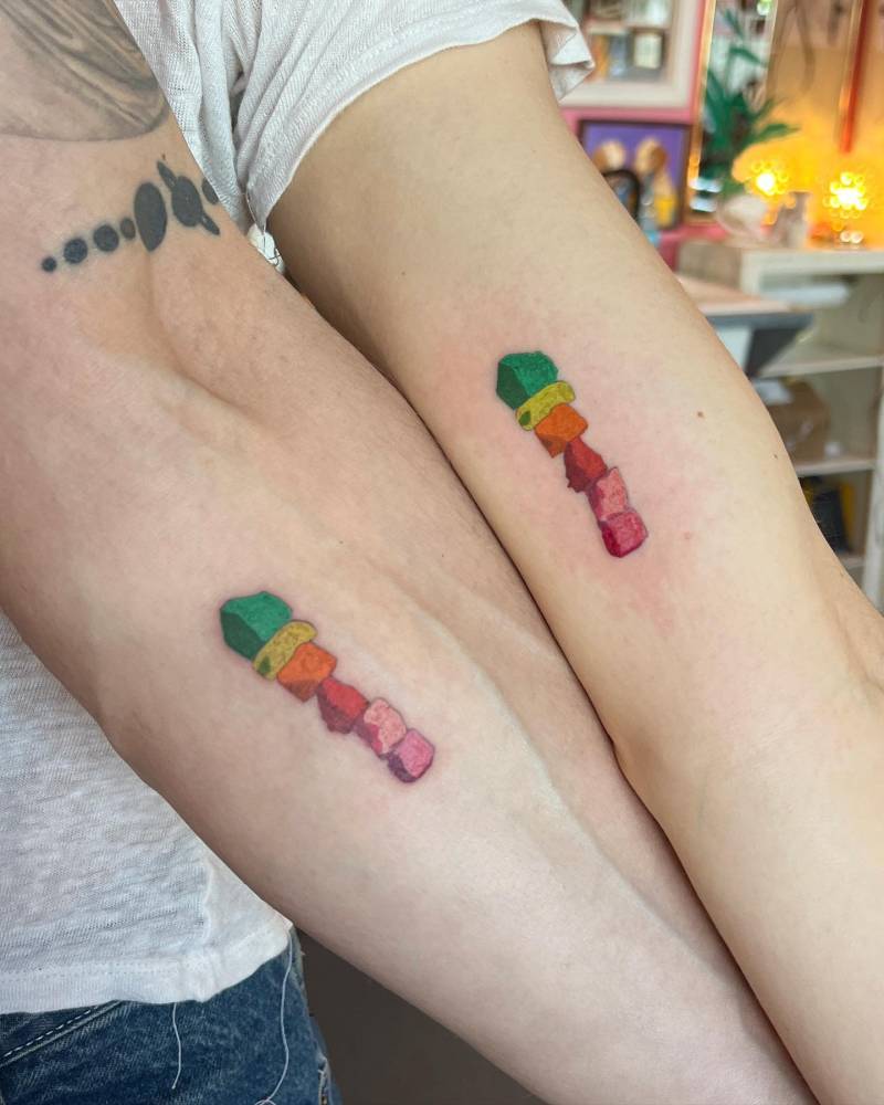 Matching 'Seven Magic Mountains' tattoo for couple.