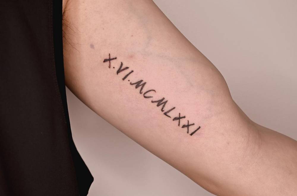 Date in roman numerals tattooed on the inner arm.