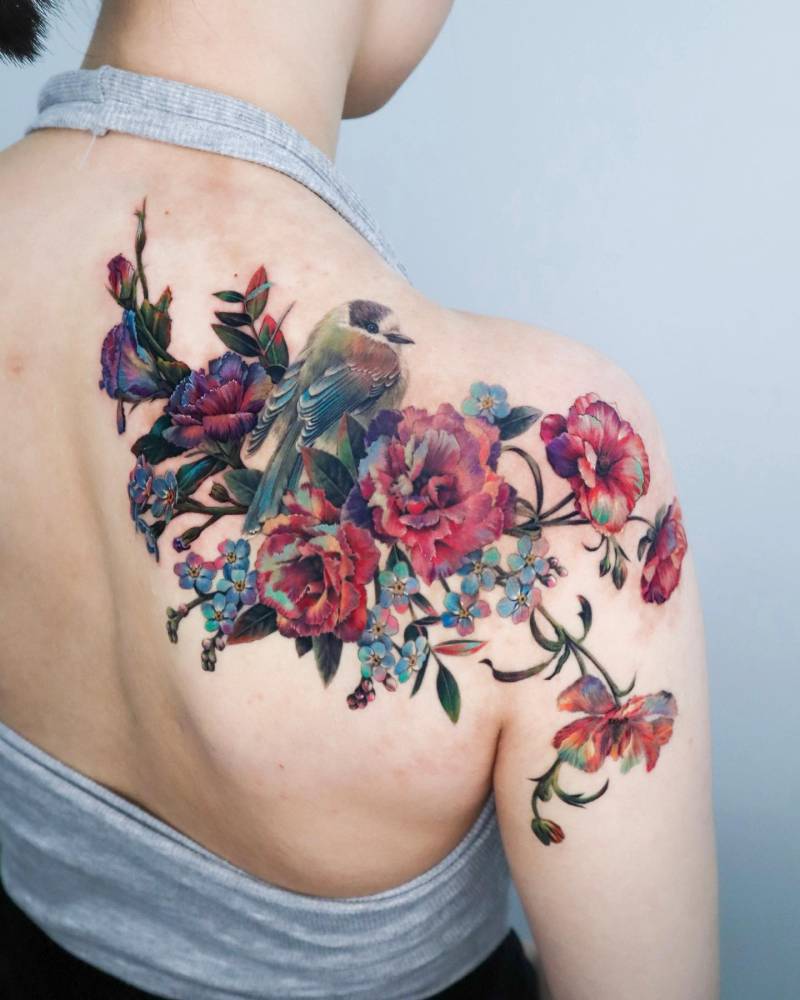Bird and flowers birthmark cover up tattoo done on the shoulder blade.