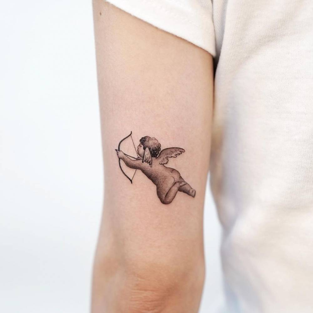 Cupid tattoo located on the tricep.