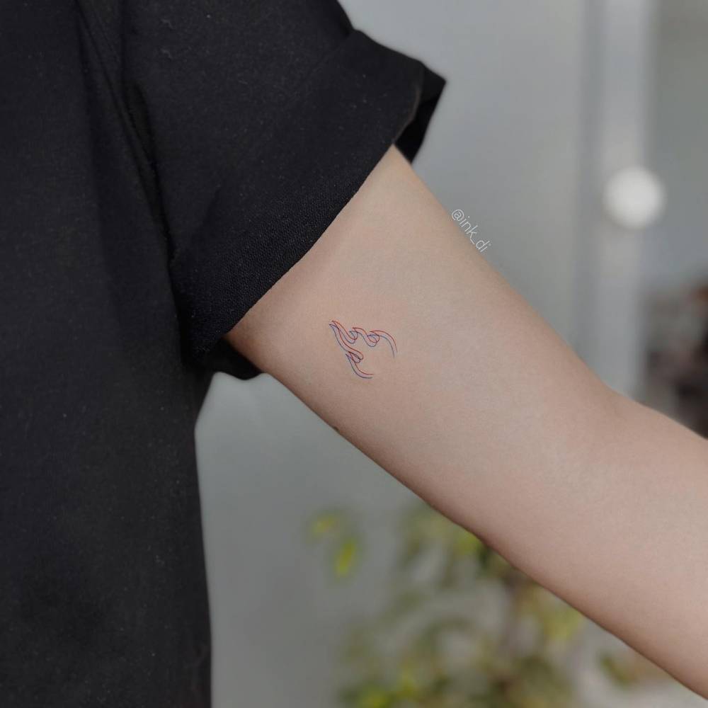 Anaglyph flame tattoo on the inner arm, minimalistic style.