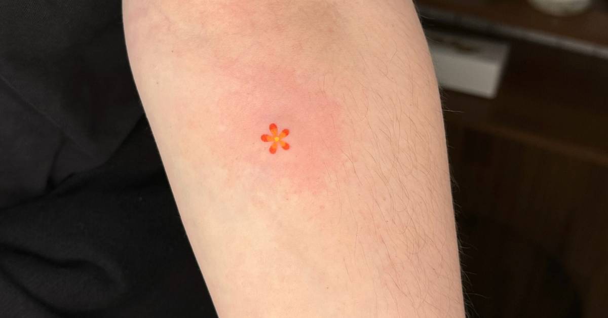Little flower tattoo hand poked on the inner forearm.