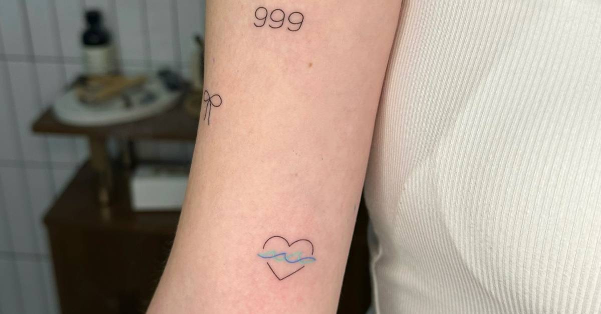 Minimalistic style wave and heart tattoo located on the