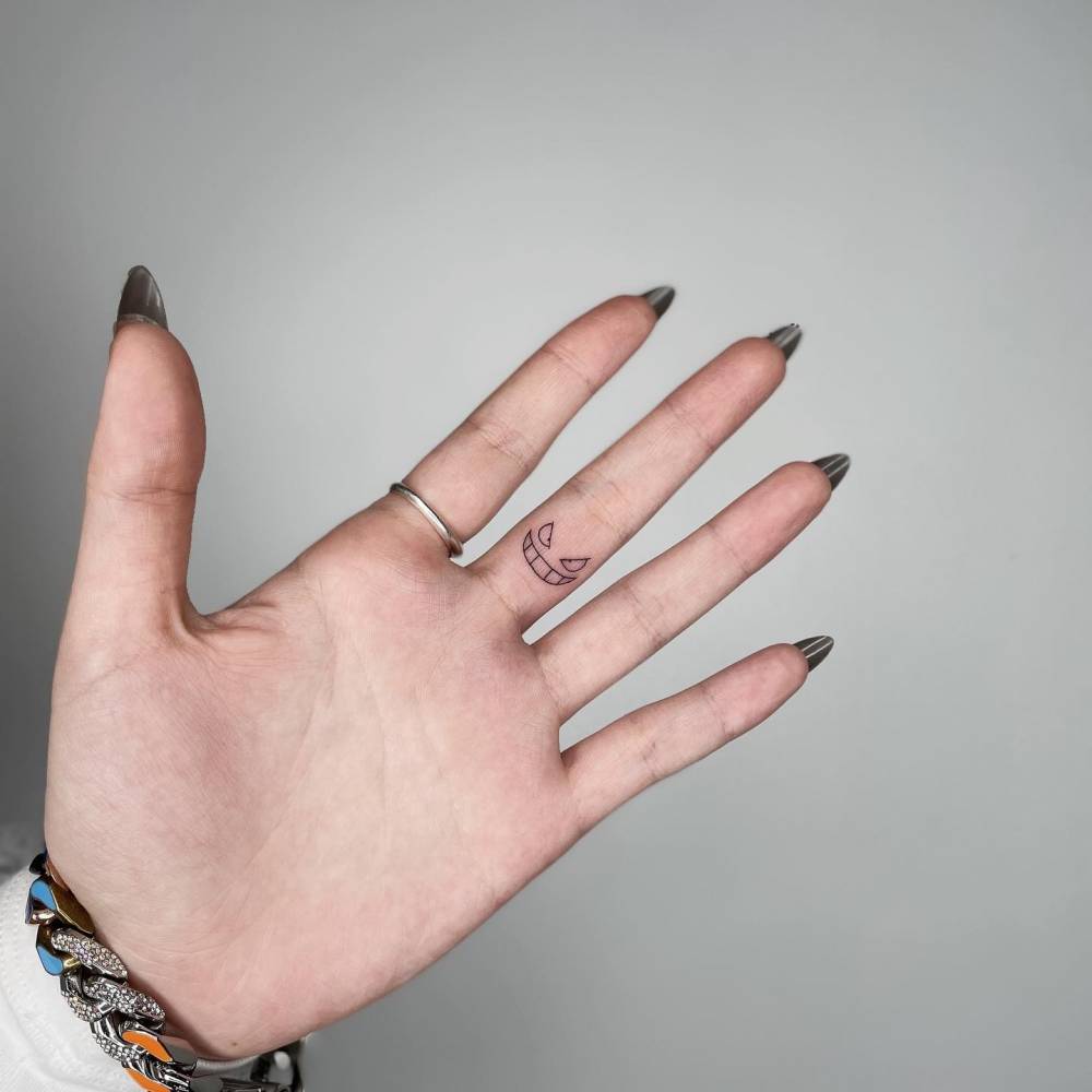 Minimalistic Gengar tattoo located on the finger.