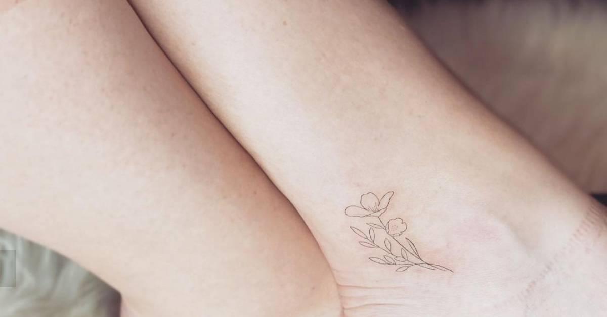 Fine line style flower tattoo located on the ankle.