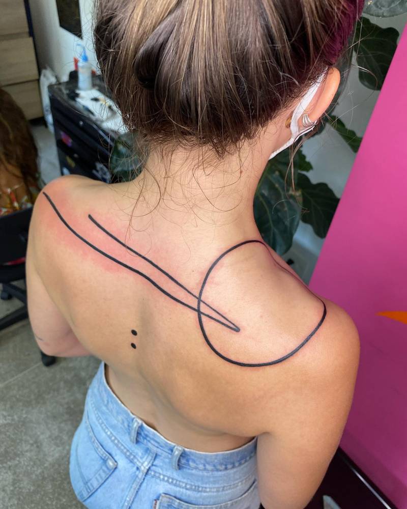 Lines and circle tattoo located on the upper back, geometric style.