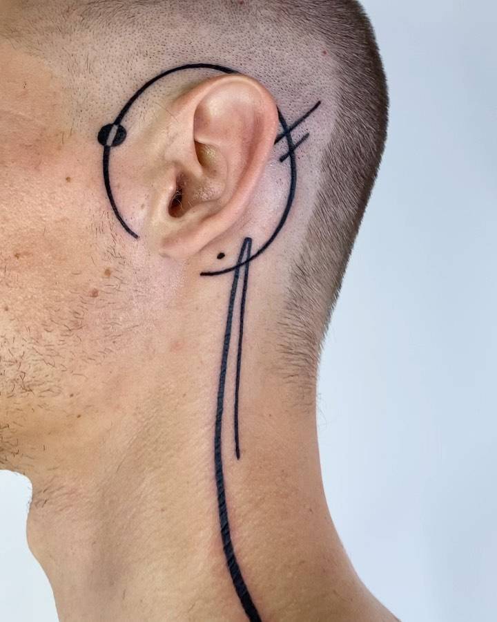 Lines and circle tattoo located on the head and neck, done in geometric style.
