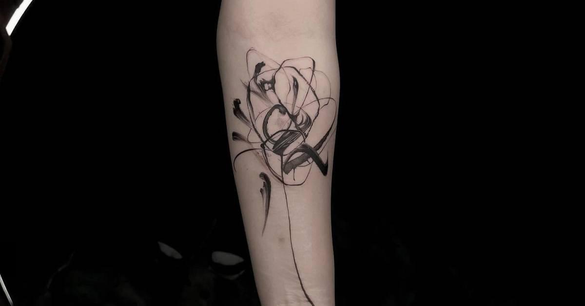 Abstract style flower tattoo located on the inner