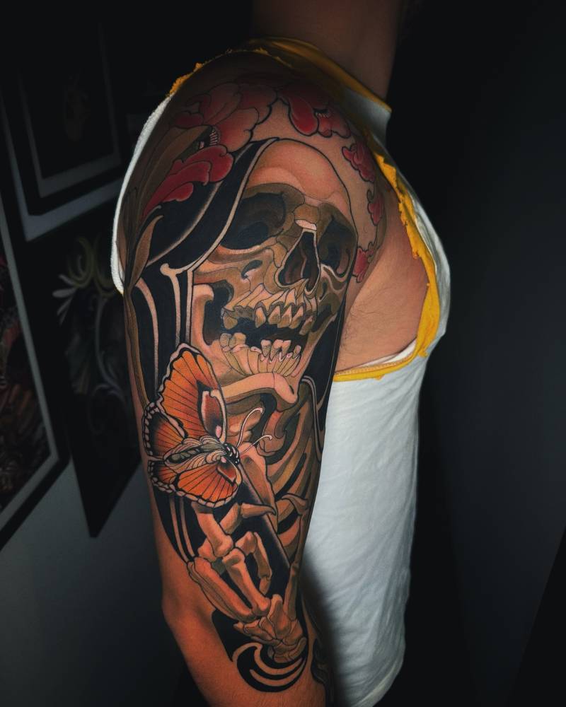 Skeleton tattoo located on the upper arm, neotraditional style.