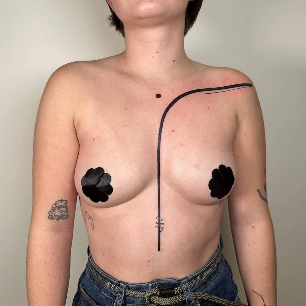 Line tattoo located on the torso, geometric style.