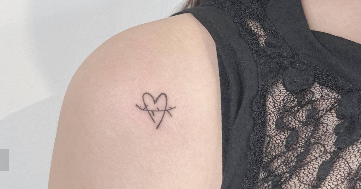 Minimalistic style heart tattoo located on the