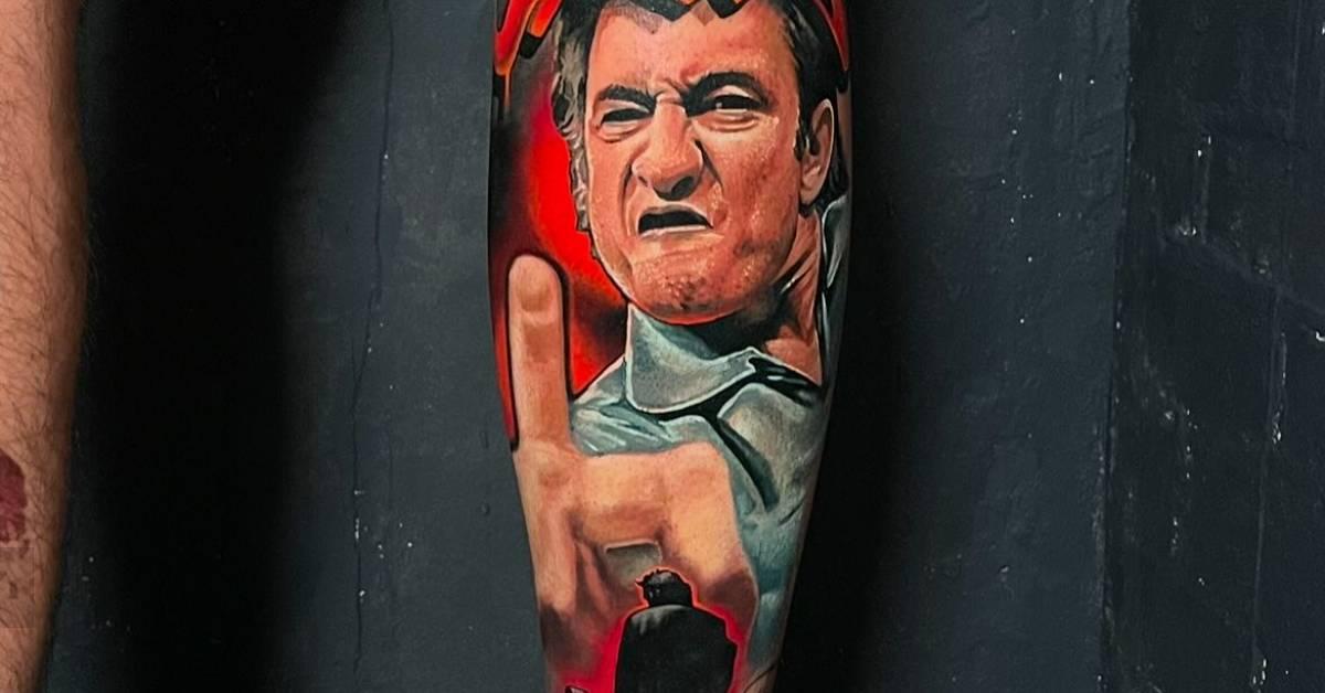 Johnny Cash portrait tattoo located on the calf,