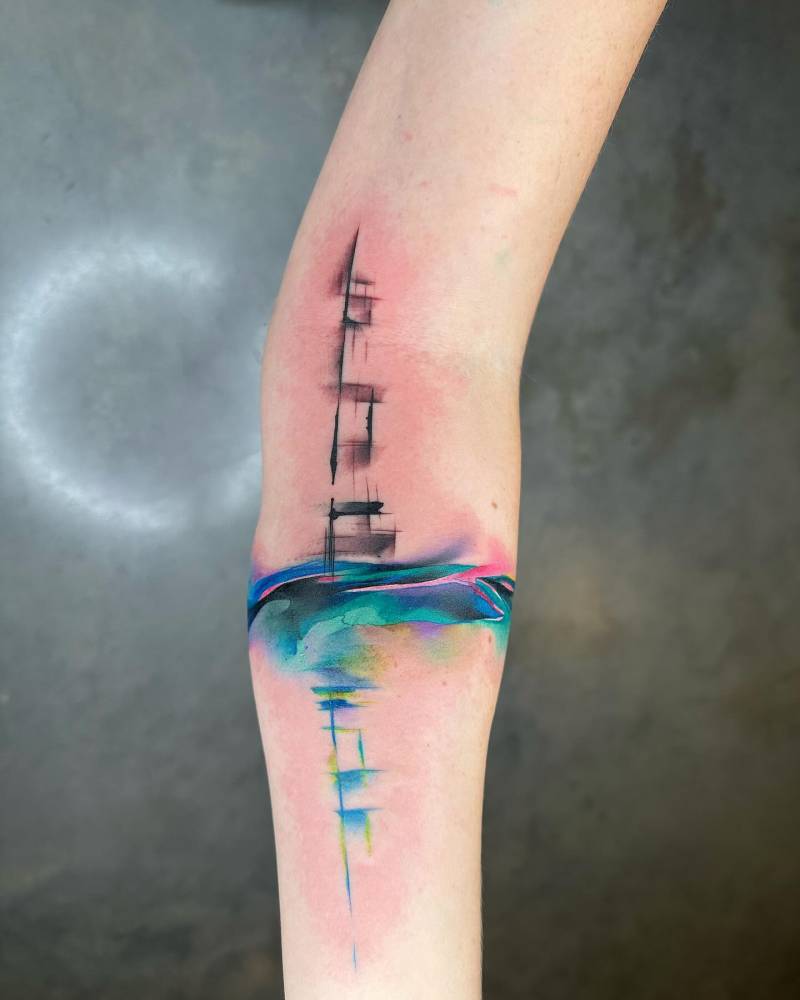Watercolor style abstract tattoo located on the inner forearm.