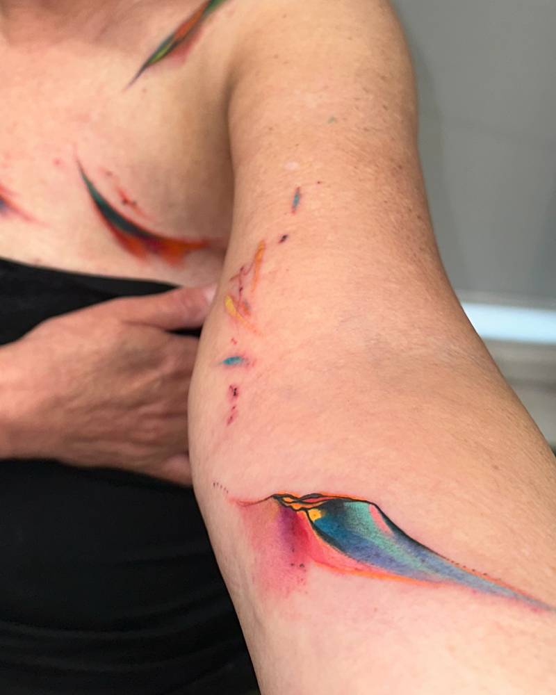 Abstract watercolor tattoo located on the inner forearm.