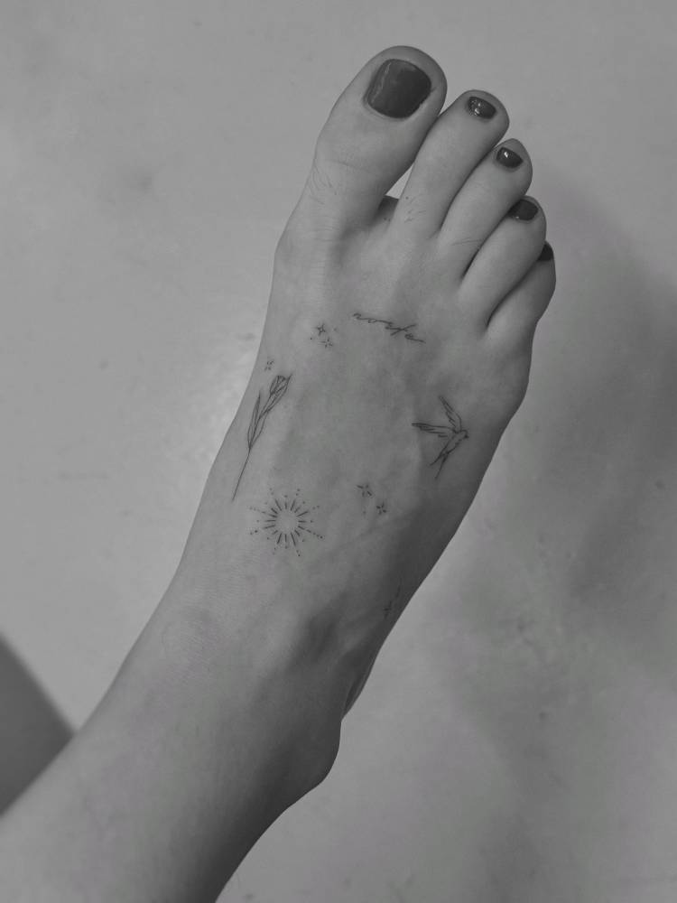 Fine line style foot composition tattoos.
