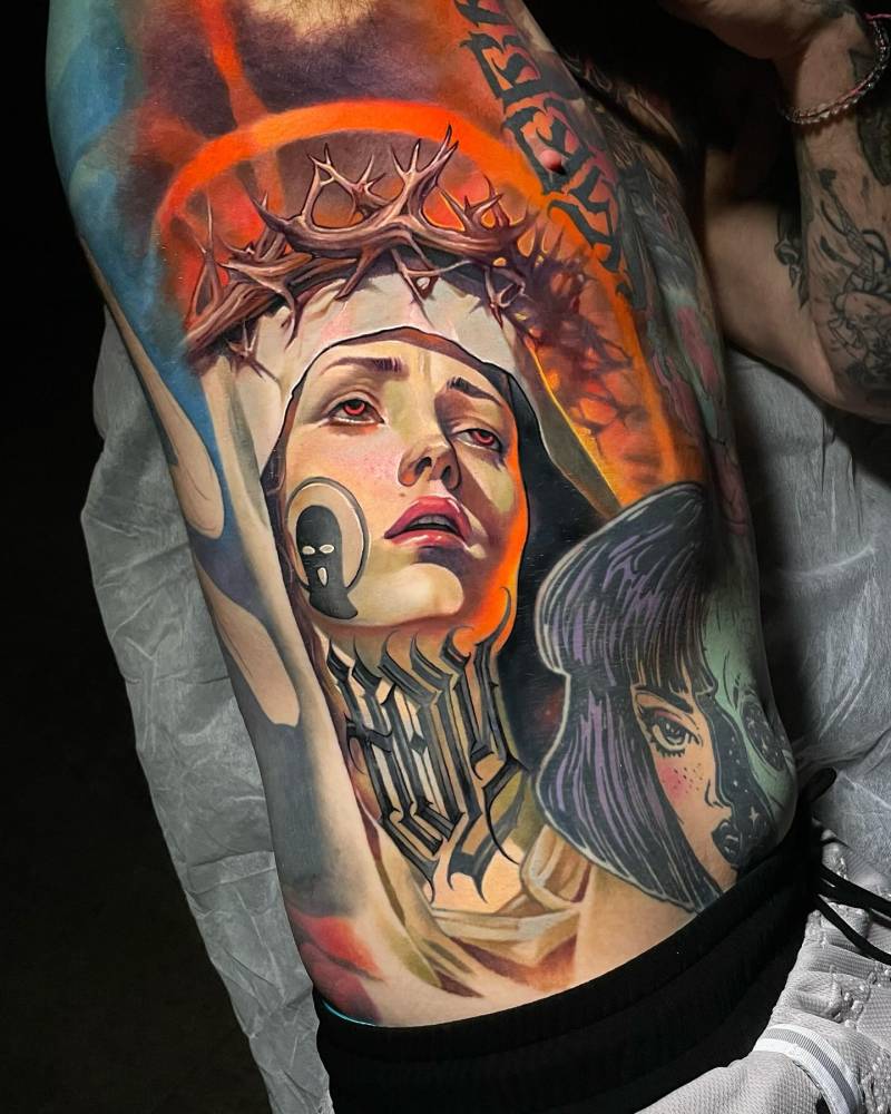 Realistic style Virgin Mary portrait tattoo located on the rib.