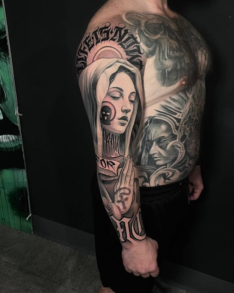 Black and grey Virgin Mary portrait tattoo sleeve.