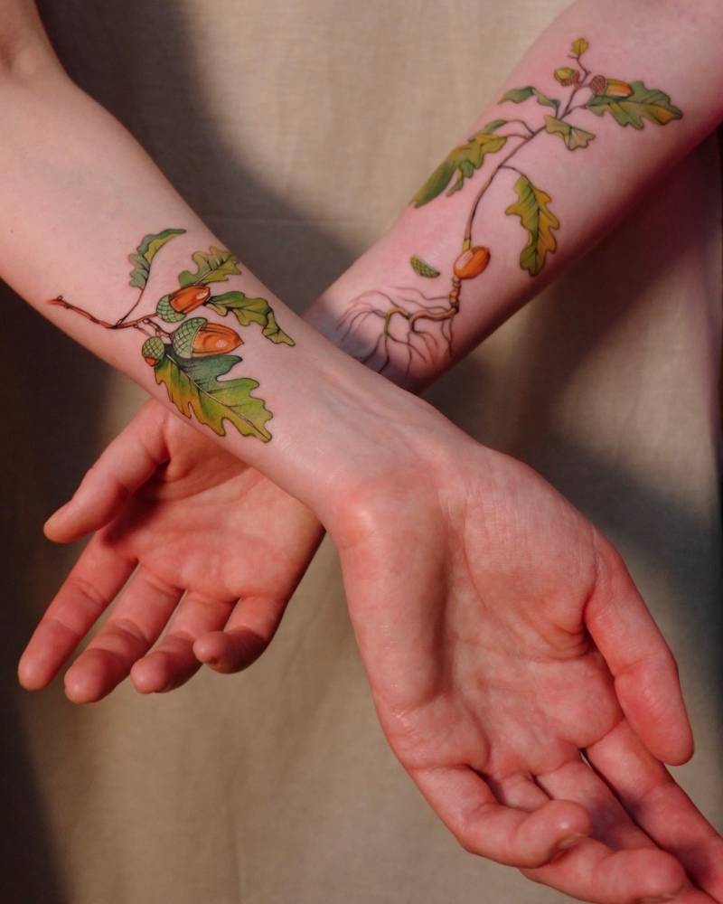 Matching acorns tattoo in illustrative style for best friends.