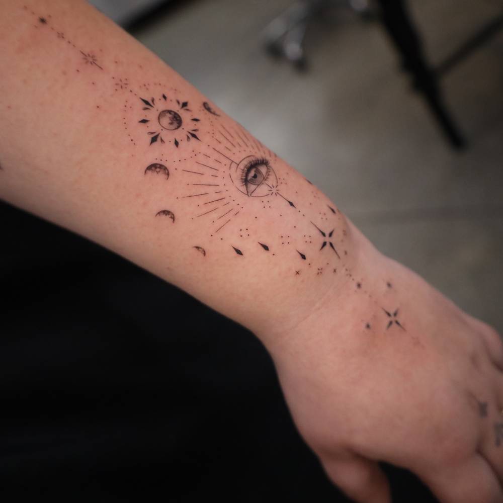 Illustrative style ornamental design tattooed on the wrist.