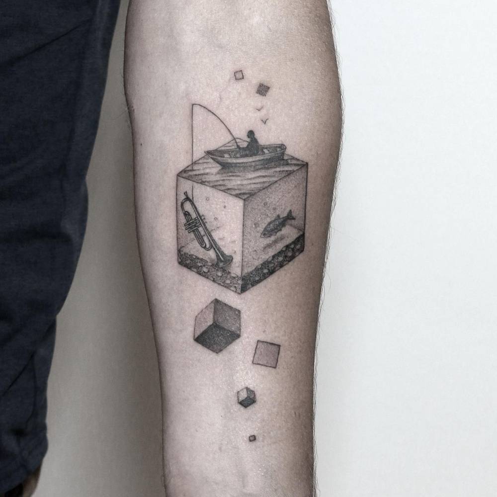 Surrealistic style fishing in a cube tattoo located on the inner forearm.