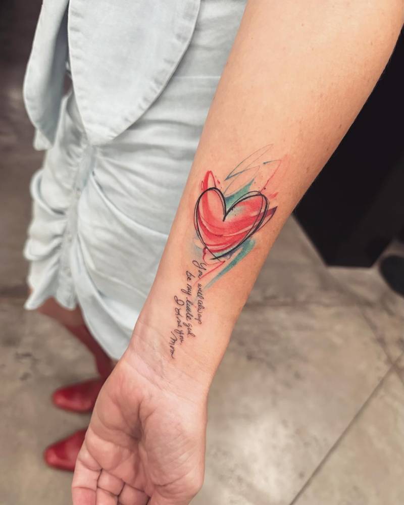 Sketch work style heart and her mom's handwriting tattooed on the wrist.