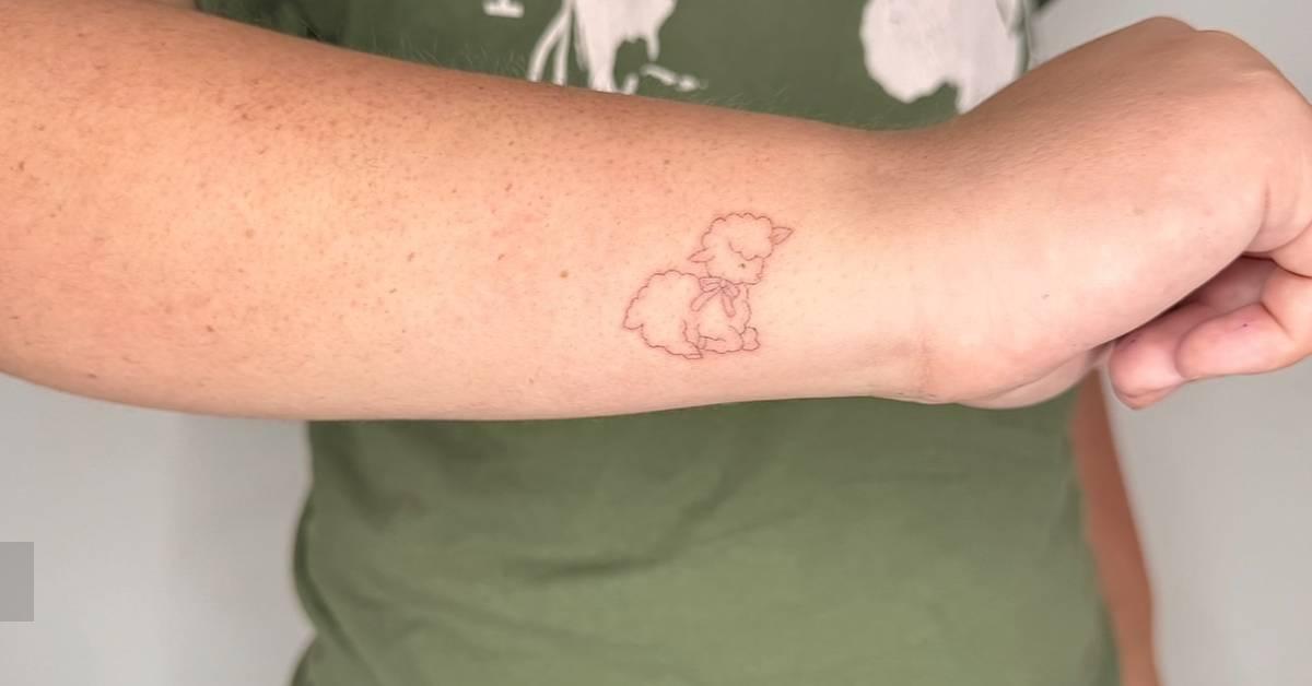 Tattoo of a lamb in fine line style placed on the