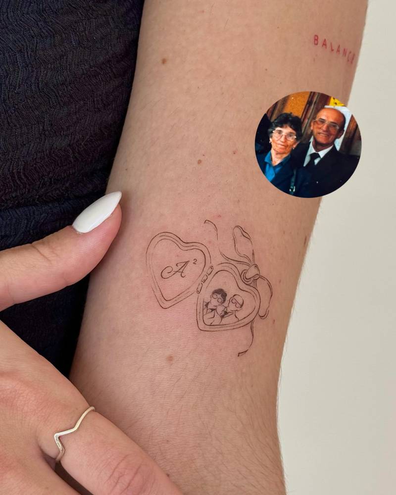 Family portrait in a pendant tattooed on the inner arm.