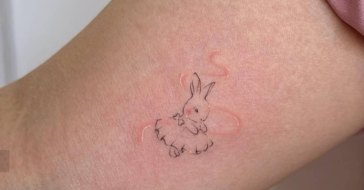 Fine line style ballet dancing rabbit tattoo located on