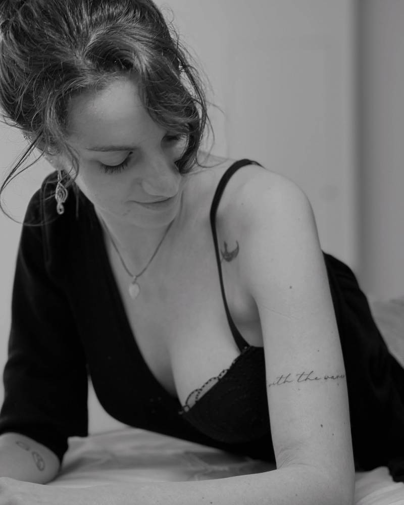 Handwritten lettering tattoo located on the upper arm.