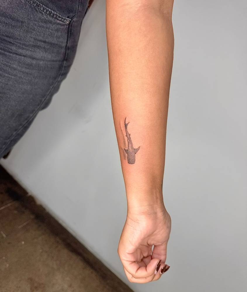 Little leopard shark tattoo located on the wrist.