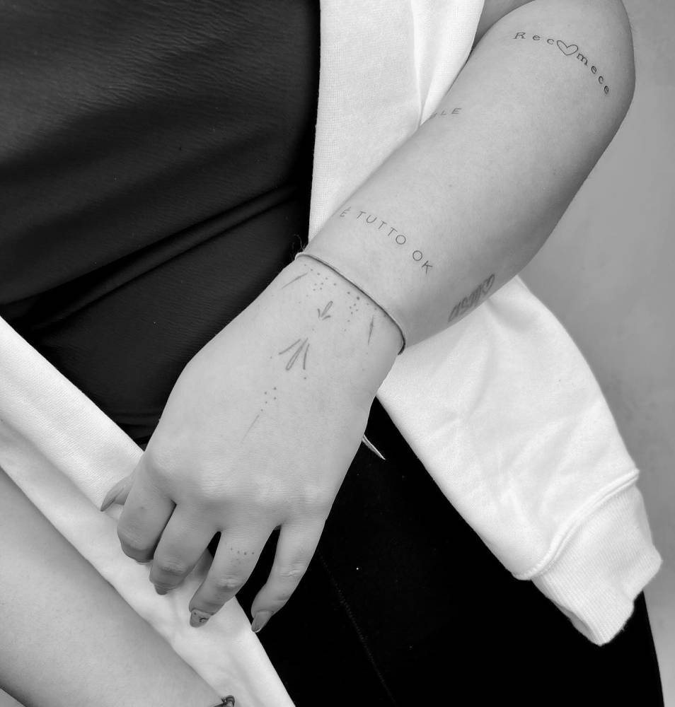 Fine line style ornamental tattoo located on the hand.