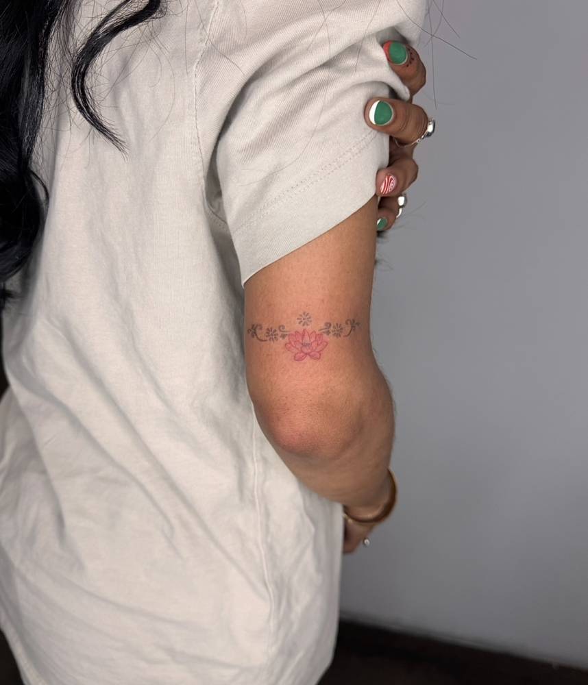 Ornamental lotus flower tattoo located on the tricep.