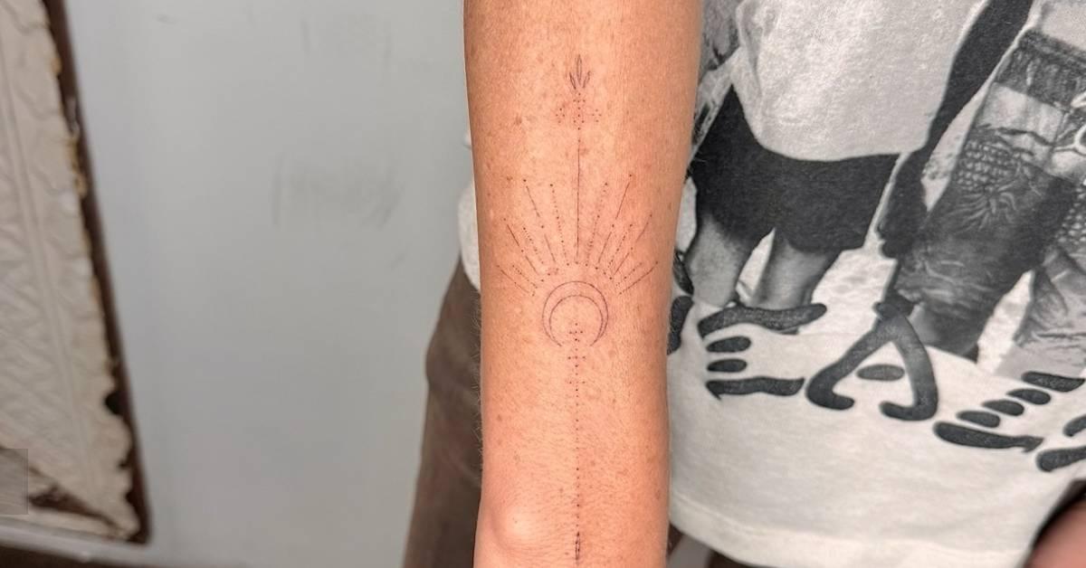 Fine line style ornamental moon tattoo placed on the