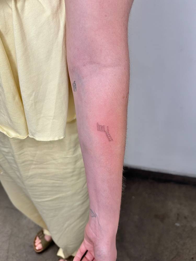 Fine line style little stairway tattoo located on the inner forearm.