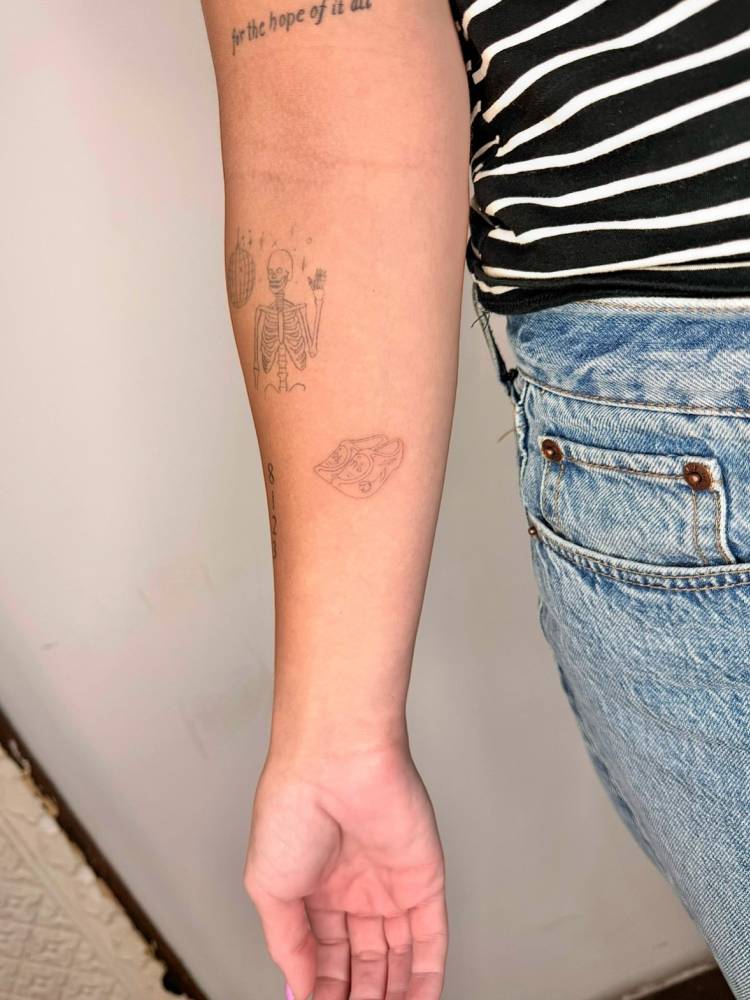 Fine line style clogs tattoo located on the inner forearm.