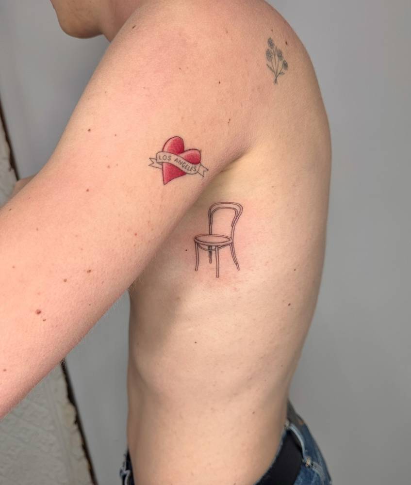 Chair tattoo located on the rib, done in fine line style.