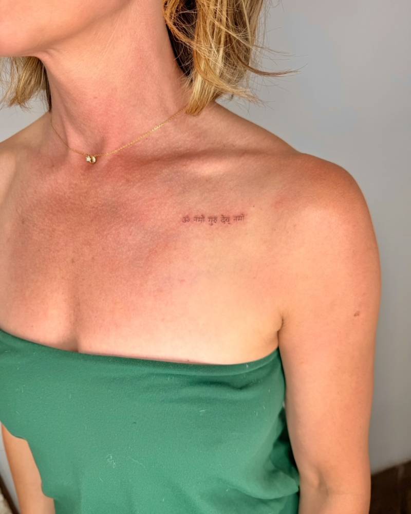 Sanskrit lettering tattoo located on the chest.