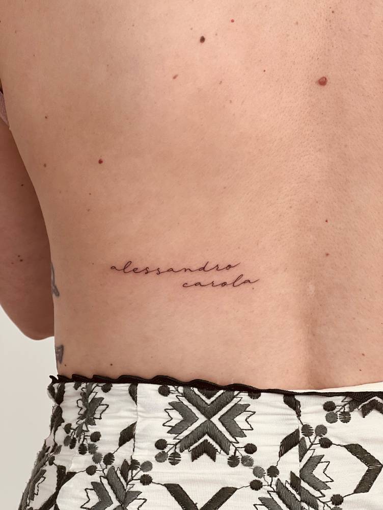 Names "Alessandro" and "Carola" tattooed on the lower back.