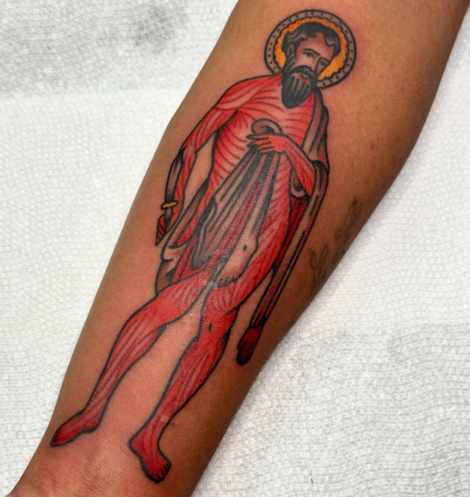 Saint Bartholomew tattoo in traditional style located on the inner forearm.