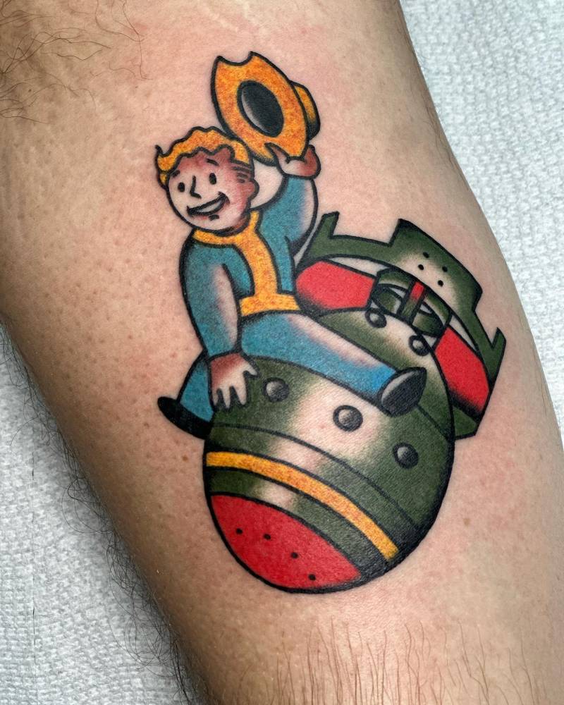 Fallout guy riding a bomb tattooed on the inner arm, cartoon style.