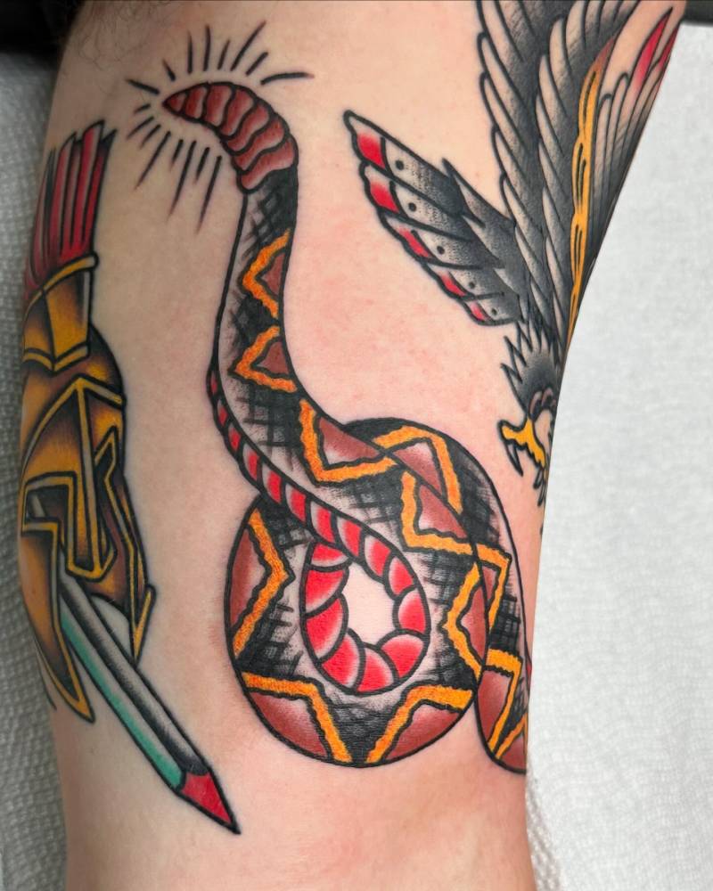 Rattlesnake in traditional style tattooed on the inner arm.