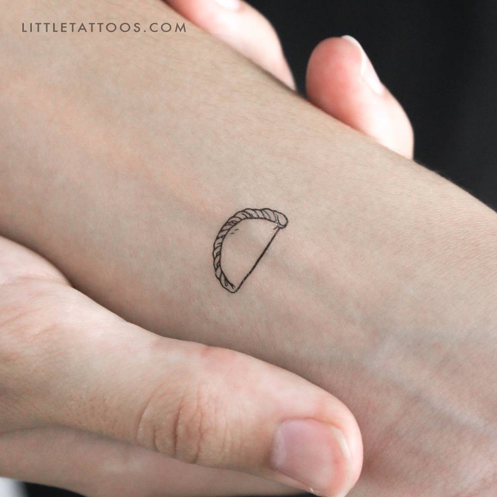 Empanadilla temporary tattoo in fine line style.