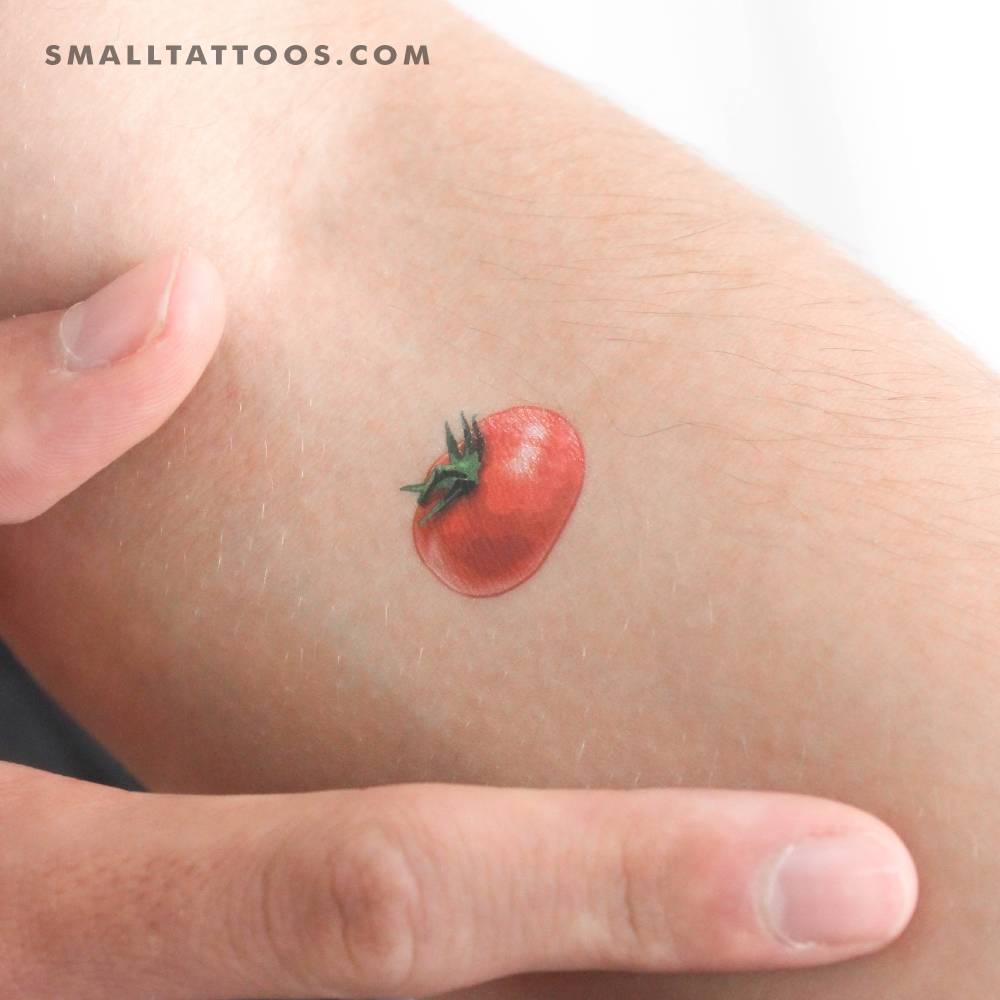Micro-realistic style red tomato temporary tattoo placed on the inner forearm.