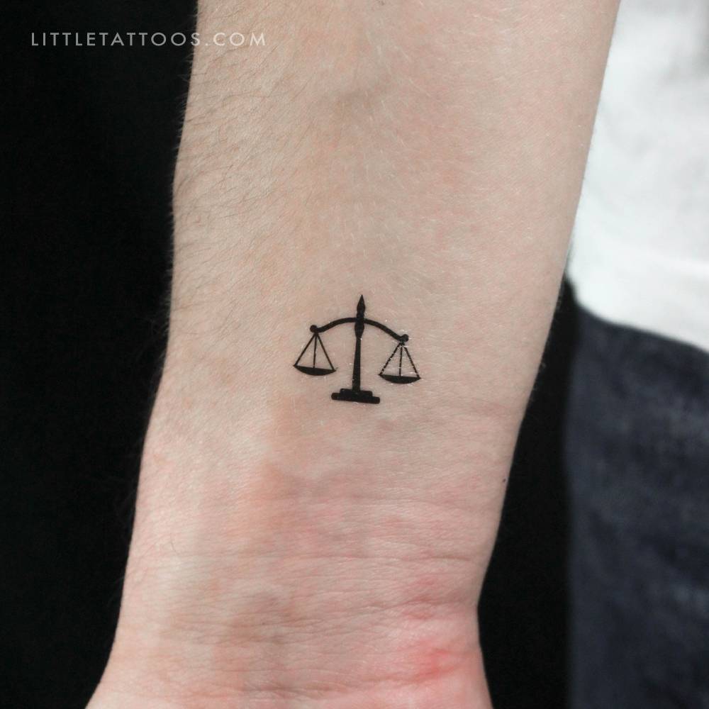 Scale temporary tattoo located on the wrist.