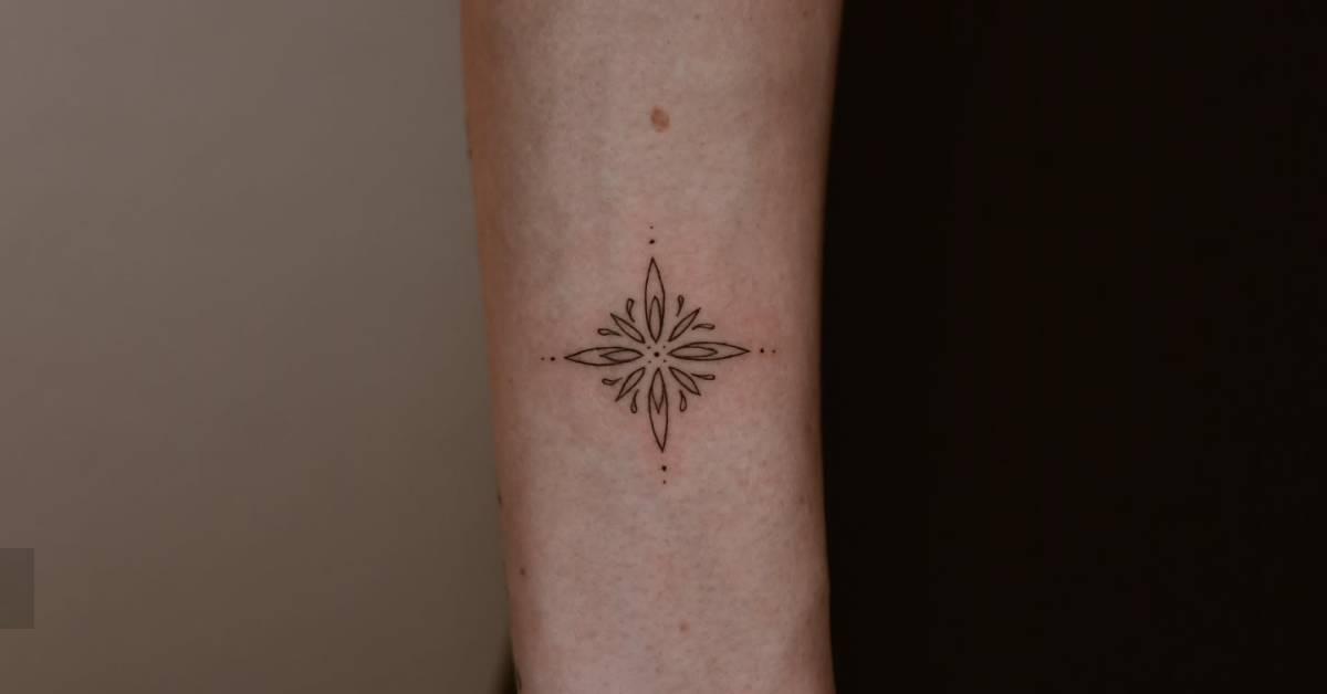 Fine line style ornamental tattoo located on the