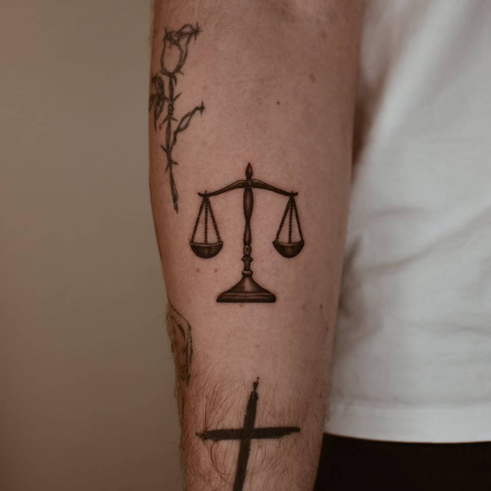 Blackwork style scale tattoo located on the inner forearm.