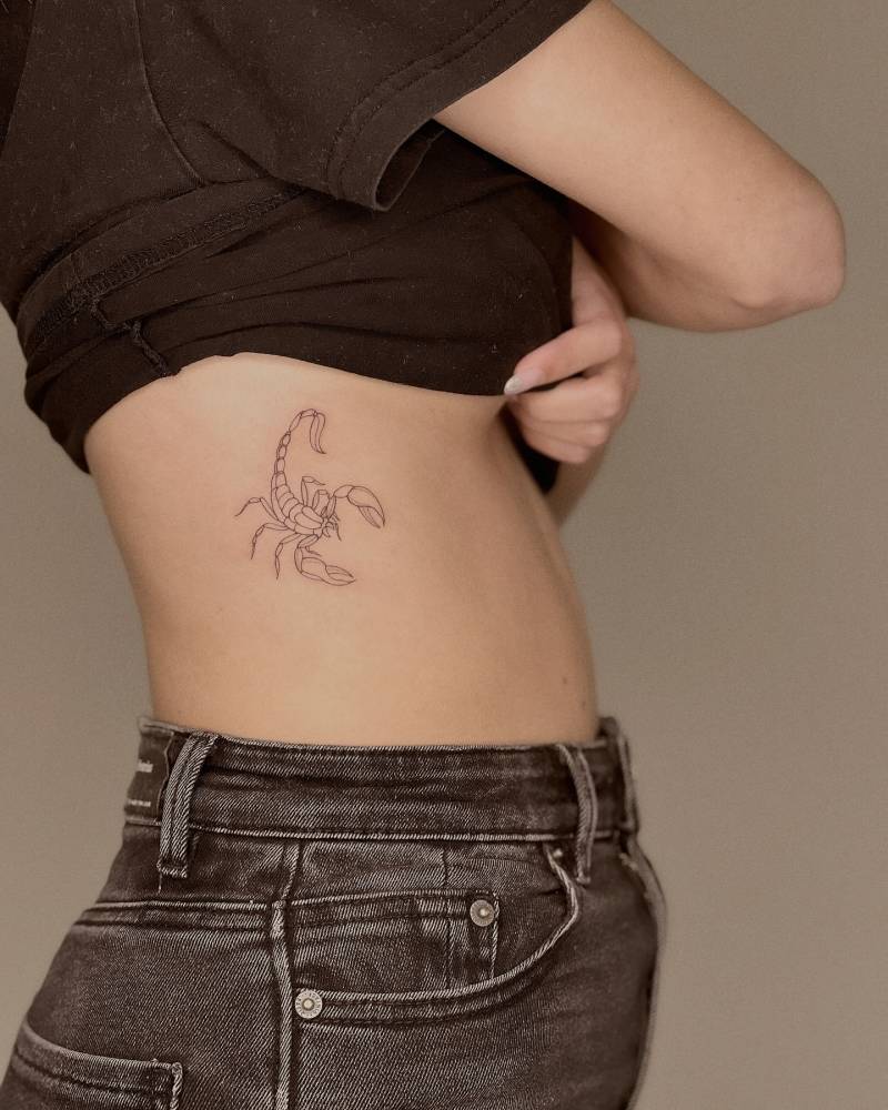 Scorpion tattoo in fine line style located on the rib.