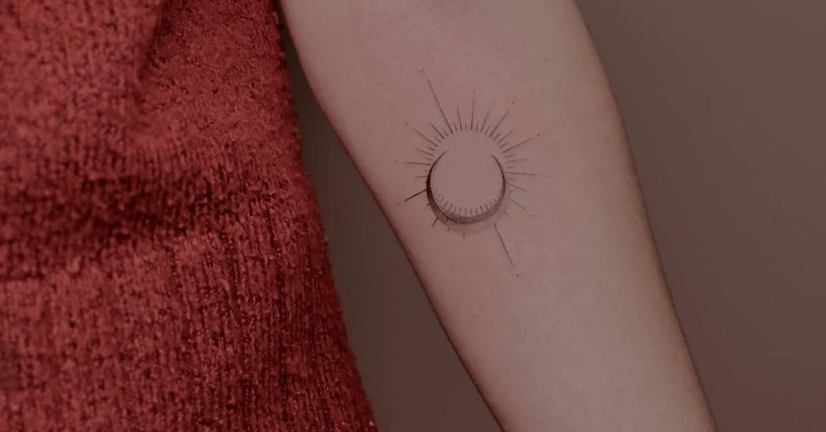 Sun and moon tattoo in fine line style placed on the