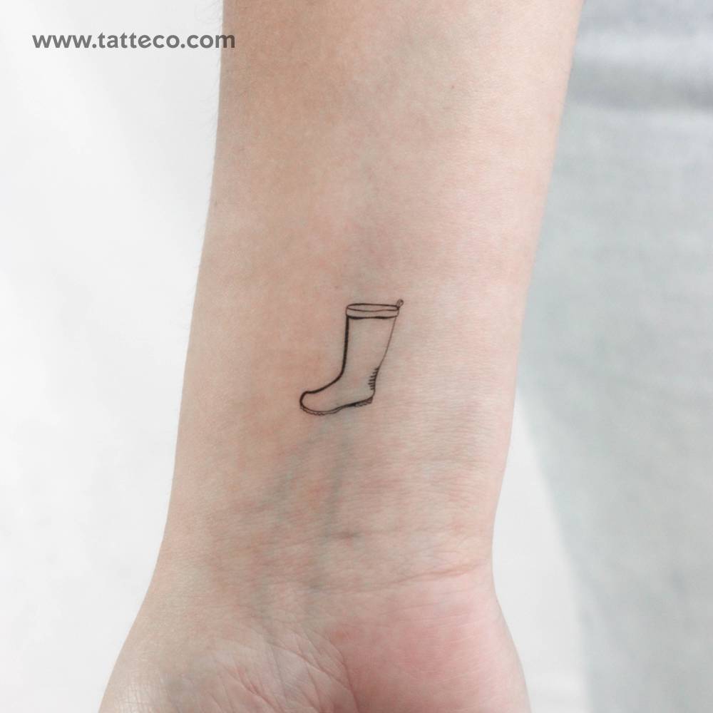 Fine line style rain boot temporary tattoo located on the wrist.